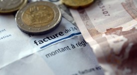 This picture taken on January 01, 2013 shows a EDF electricity bill with euros coins on in the western city of Rennes.  AFP PHOTO / DAMIEN MEYER        (Photo credit should read DAMIEN MEYER/AFP/Getty Images)