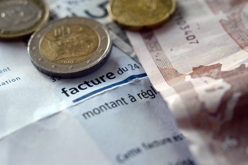 This picture taken on January 01, 2013 shows a EDF electricity bill with euros coins on in the western city of Rennes.  AFP PHOTO / DAMIEN MEYER        (Photo credit should read DAMIEN MEYER/AFP/Getty Images)